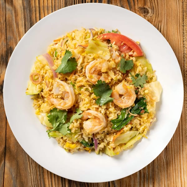 Sen Noodle House's shrimp fried rice with vegetables and cilantro on a white plate.